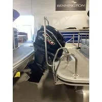 Slide: The Image of 2023 Bennington L Bowrider 23 Swingback with outboard motor in showroom. - 6