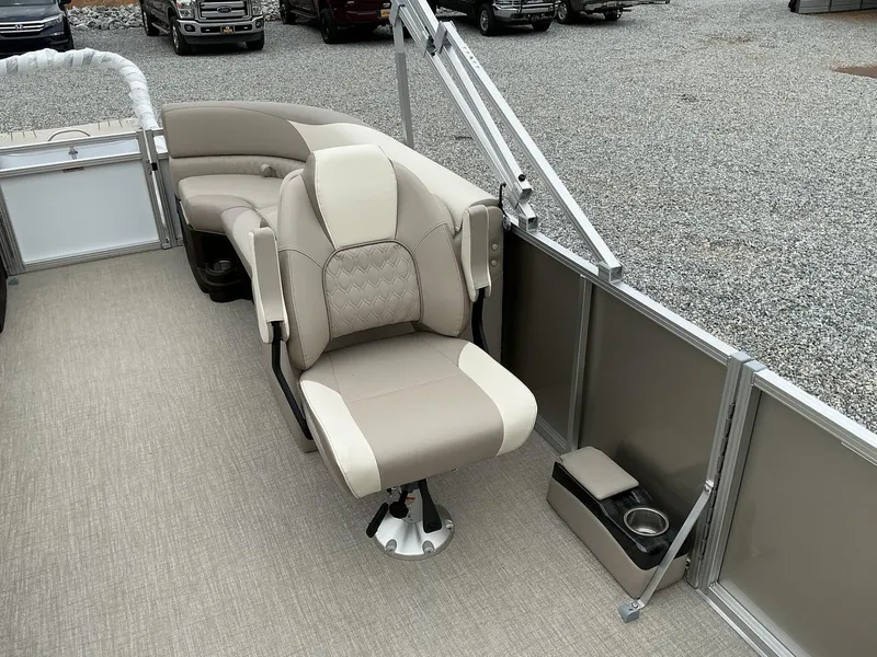 Slide: The Image of 2025 Avalon LSZ 23 Quad Lounger boat interior with beige seating and cup holder. - 10