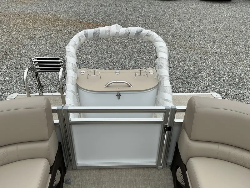 Slide: The Image of 2025 Avalon LSZ 23 Quad Lounger boat interior with beige seating and railing. - 7