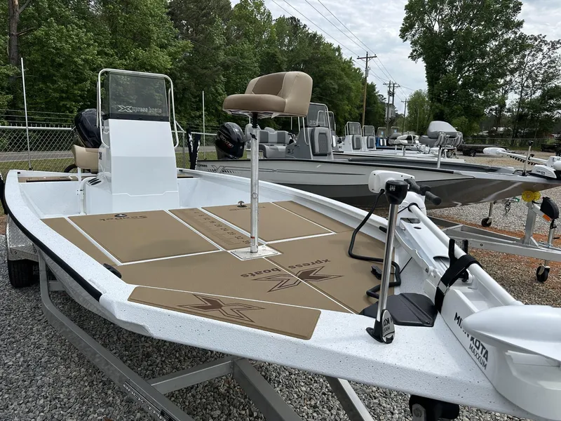 Slide: The Image of 2025 Xpress Hyper-Lift Bay Series 210 BAY-175 HP boat on display outdoors. - 2