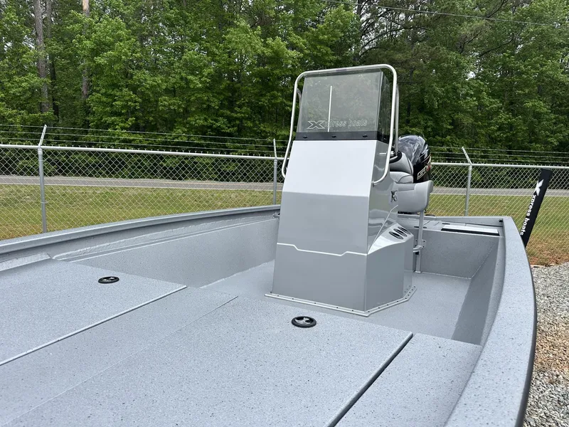 Slide: The Image of 2025 Xpress Hyper-Lift Bay Series 210 BAY-175 HP boat, sleek design, parked outdoors. - 3