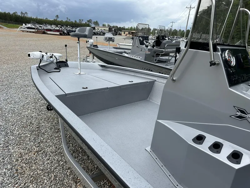 Slide: The Image of 2025 Xpress Hyper-Lift Bay Series 210 BAY-175 HP boat on gravel lot, side view. - 5