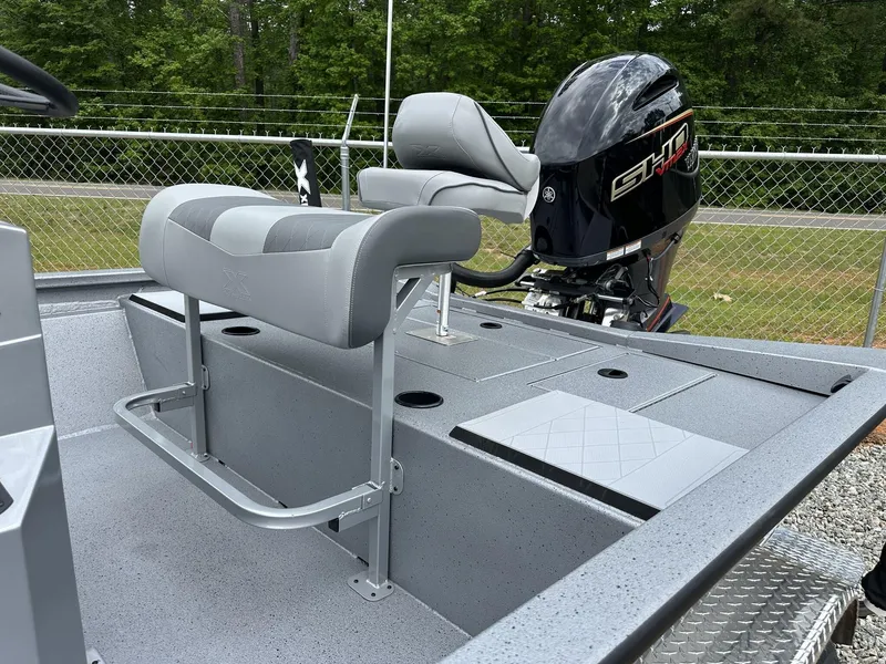 Slide: The Image of 2025 Xpress Hyper-Lift Bay Series 210 BAY-175 HP boat interior with seating and motor. - 8