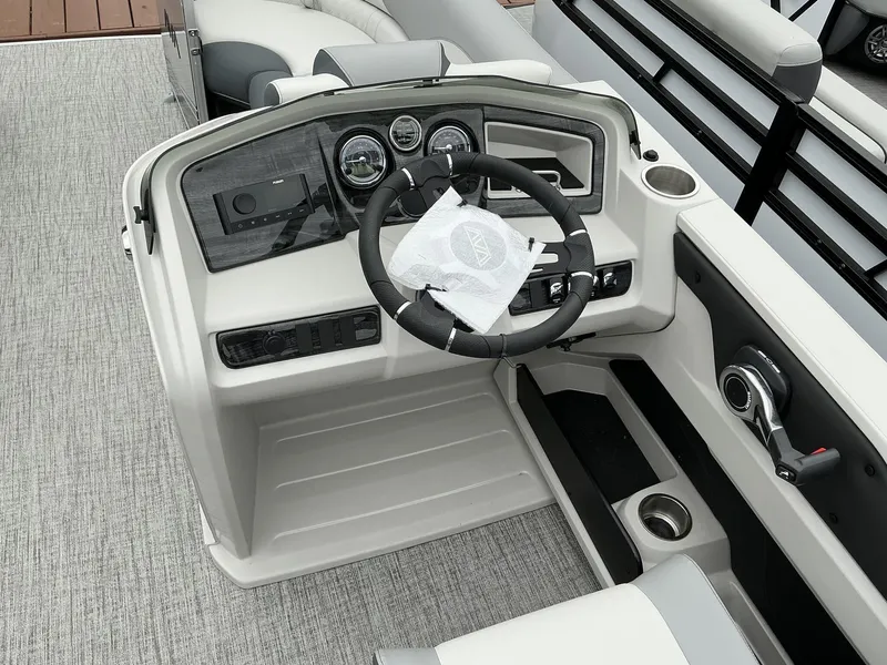 Slide: The Image of 2025 Avalon LSZ 23 Rear Lounger boat dashboard with steering wheel and controls. - 13