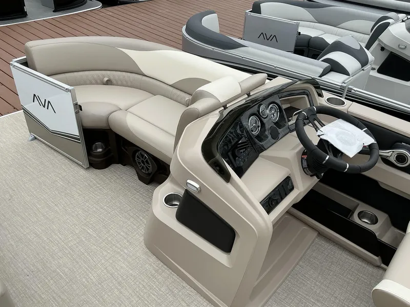 Slide: The Image of 2025 Avalon LSZ 23 Quad Lounger boat interior with beige seating and modern dashboard. - 5
