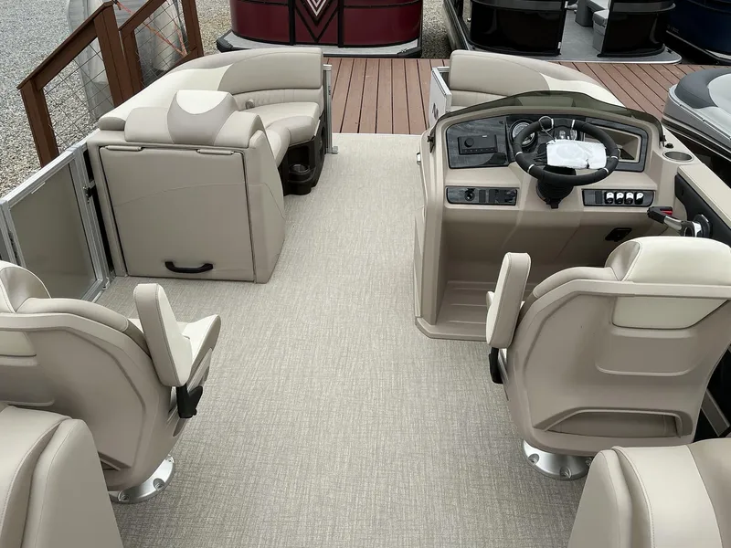 Slide: The Image of 2025 Avalon LSZ 23 Quad Lounger interior with beige seating and modern helm. - 8