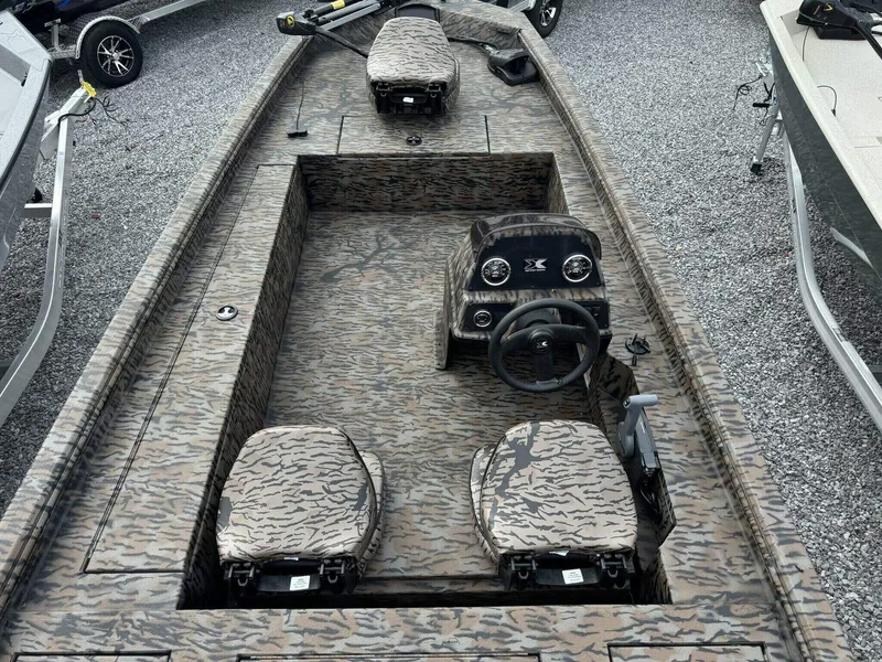 Slide: The Image of 2025 Xpress Xplorer Series XP180 boat with camouflage interior, gravel background. - 4