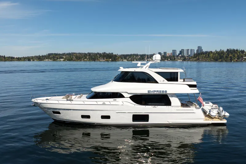Slide: The Image of 2018 Ocean Alexander 70E Motoryacht on calm water with city skyline in background. - 1