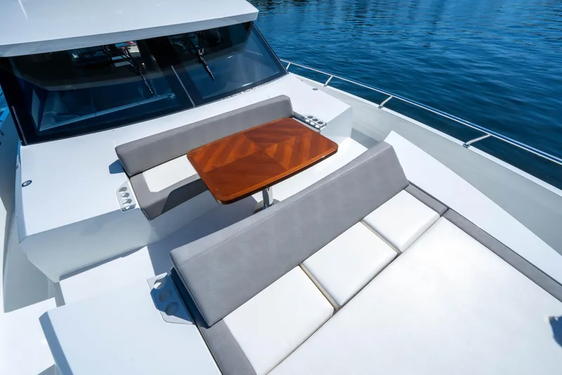 Slide: The Image of 2018 Ocean Alexander 70E Motoryacht deck with seating and table, overlooking calm waters. - 10
