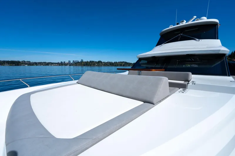 Slide: The Image of 2018 Ocean Alexander 70E Motoryacht on calm water, featuring sleek design and spacious deck. - 12