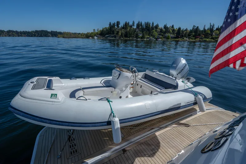 Slide: The Image of 2018 Ocean Alexander 70E Motoryacht with inflatable tender on deck, American flag visible. - 16