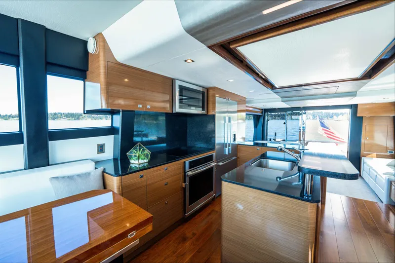 Slide: The Image of Luxurious interior of 2018 Ocean Alexander 70E Motoryacht with modern kitchen and seating area. - 22