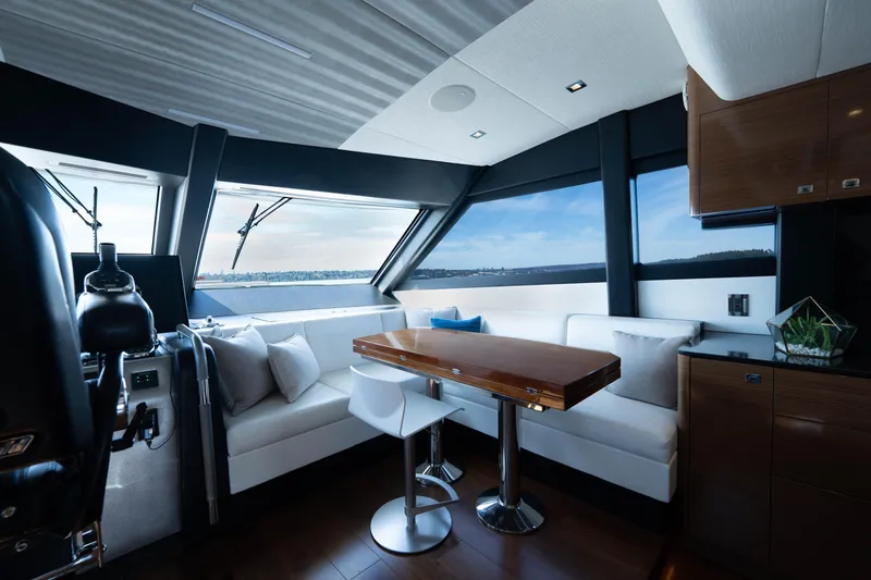 Slide: The Image of Luxurious interior of 2018 Ocean Alexander 70E Motoryacht with modern seating and panoramic windows. - 24