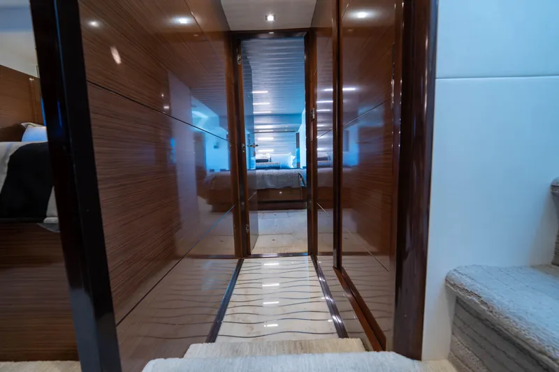 Slide: The Image of Luxurious interior hallway of 2018 Ocean Alexander 70E Motoryacht, featuring sleek wood paneling. - 26