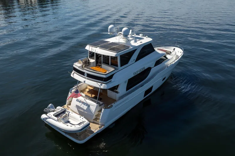 Slide: The Image of 2018 Ocean Alexander 70E Motoryacht cruising on calm waters, rear view. - 3