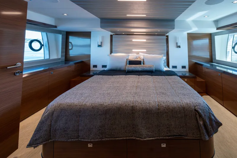 Slide: The Image of Luxurious bedroom interior of 2018 Ocean Alexander 70E Motoryacht with modern design and large windows. - 35