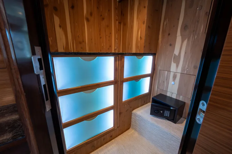 Slide: The Image of Luxurious interior of 2018 Ocean Alexander 70E Motoryacht with illuminated storage and safe. - 38