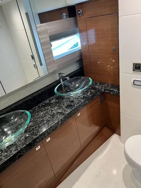 Slide: The Image of Luxurious bathroom in 2018 Ocean Alexander 70E Motoryacht with dual glass sinks and marble countertop. - 39