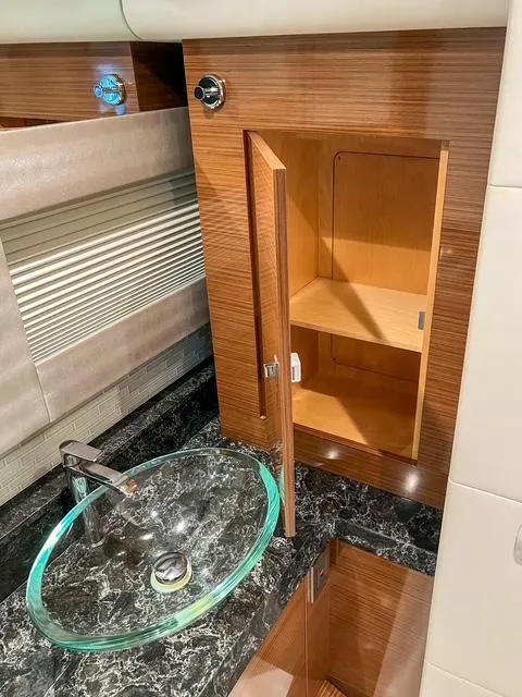 Slide: The Image of Luxurious bathroom interior of 2018 Ocean Alexander 70E Motoryacht with glass sink and wooden cabinet. - 42