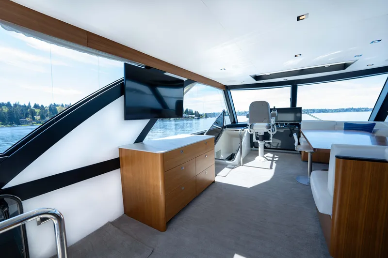 Slide: The Image of Luxurious interior of 2018 Ocean Alexander 70E Motoryacht with modern furnishings and panoramic windows. - 45