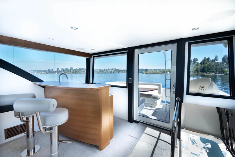 Slide: The Image of Luxurious interior of 2018 Ocean Alexander 70E Motoryacht with bar and scenic water views. - 47