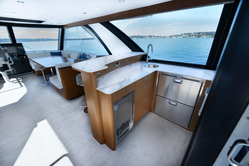 Slide: The Image of Luxurious interior of 2018 Ocean Alexander 70E Motoryacht with modern kitchen and seating area. - 49
