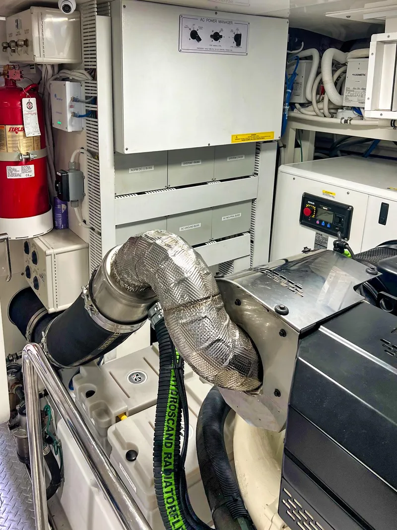 Slide: The Image of Engine room of 2018 Ocean Alexander 70E Motoryacht, featuring mechanical components and safety equipment. - 54