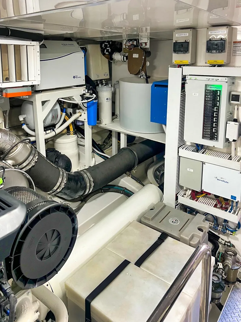 Slide: The Image of Engine room of 2018 Ocean Alexander 70E Motoryacht, showcasing complex machinery and systems. - 55
