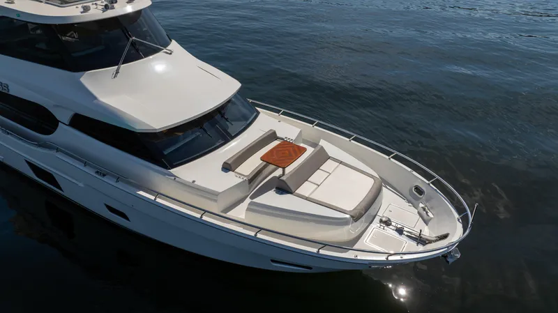 Slide: The Image of 2018 Ocean Alexander 70E Motoryacht on calm water, featuring spacious deck and sleek design. - 8
