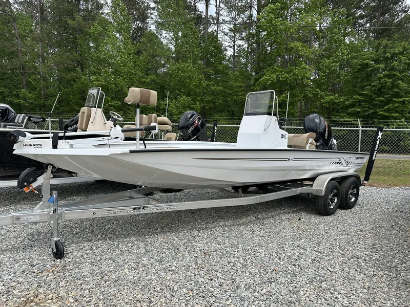 Slide: The Image of 2025 Xpress Hyper-Lift Bay Series 210 BAY-175 HP boat on trailer, parked outdoors. - 1