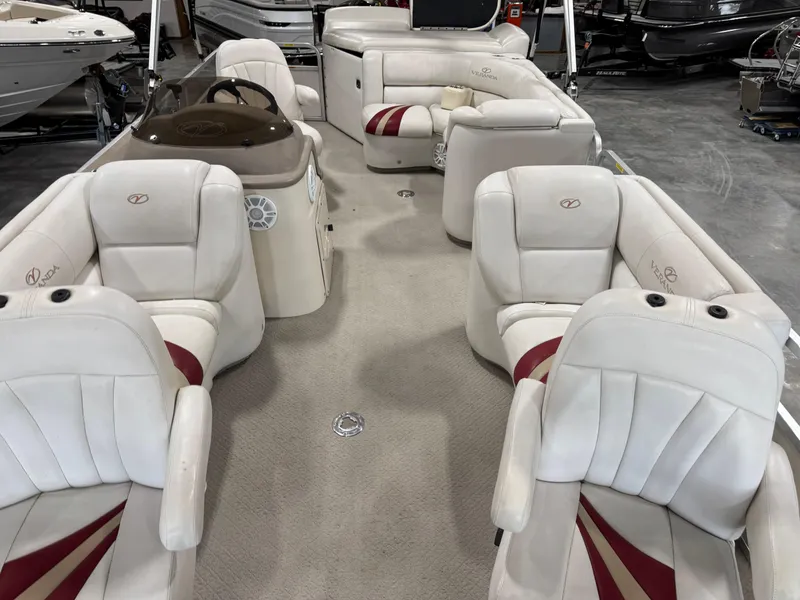 Slide: The Image of 2007 Veranda VP 22 pontoon boat interior with white and red seating in a showroom. - 10