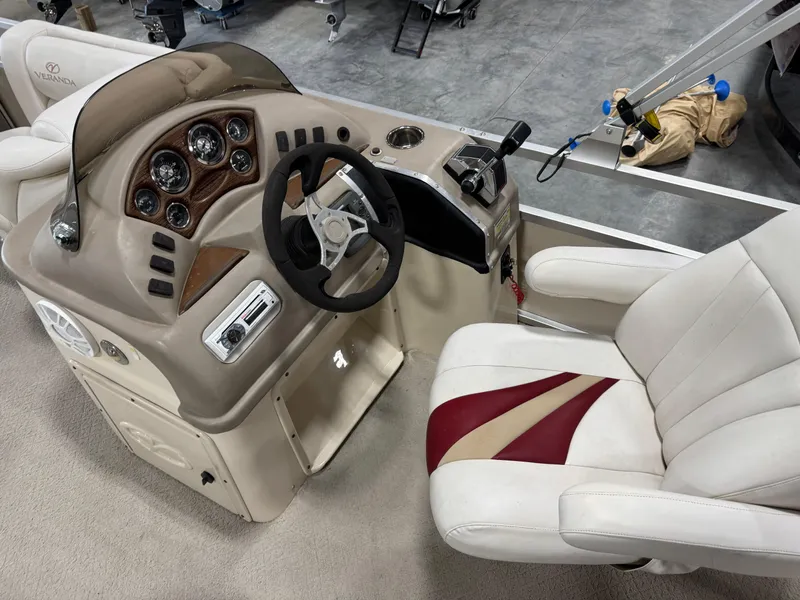 Slide: The Image of Captain's seat and helm of a 2007 Veranda VP 22 boat, featuring gauges and steering wheel. - 12