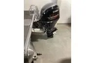 Slide: The Image of 2024 Bennington SV Line boat with outboard motor in a garage setting. - 12