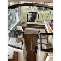 Slide: The Image of 2023 Starcraft SVX 210 OB DC boat interior with seating and outboard motor. - 4