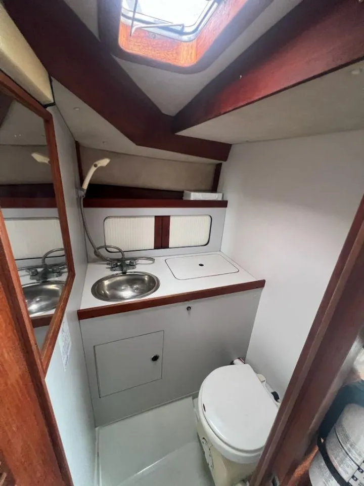 Slide: The Image of 1988 Black Watch 30 Sportfish Convertible boat bathroom with sink and toilet. - 10