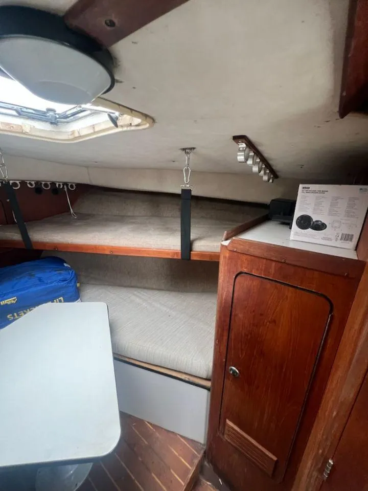 Slide: The Image of Interior cabin of 1988 Black Watch 30 Sportfish Convertible with wooden finishes and bunk beds. - 12