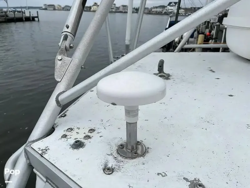 Slide: The Image of 1988 Black Watch 30 Sportfish Convertible boat deck with metal fittings and water view. - 4