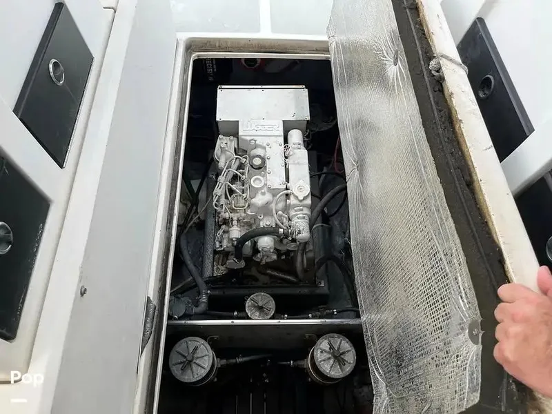 Slide: The Image of Engine compartment of 1988 Black Watch 30 Sportfish Convertible boat, showing detailed machinery. - 6