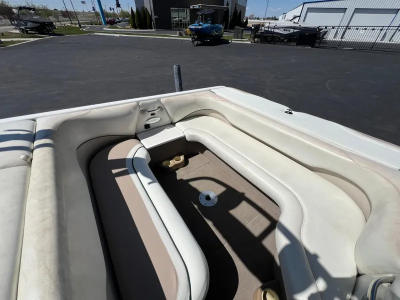 Slide: The Image of 2003 Malibu 23 XTi boat interior with white seating and open deck area. - 11