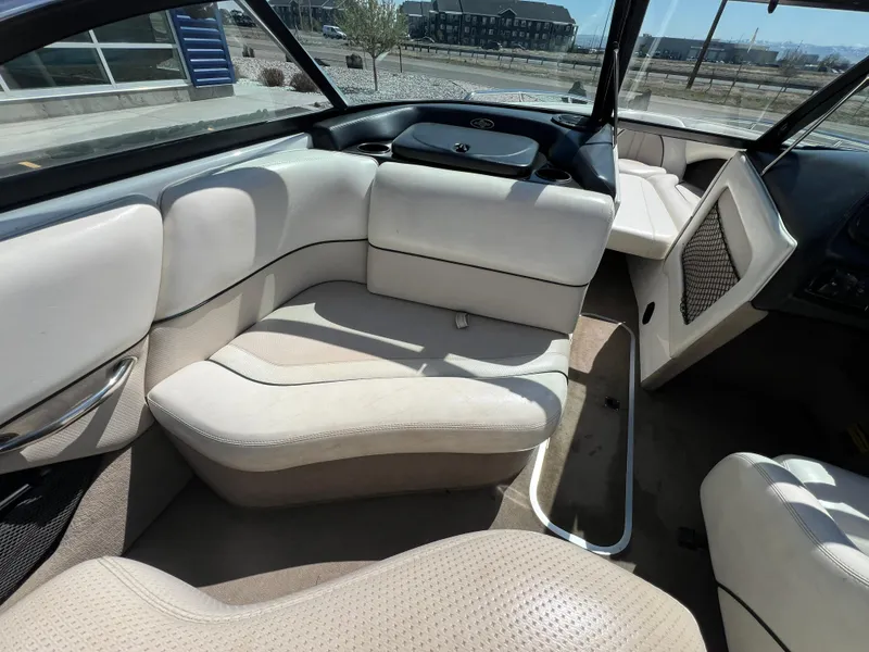 Slide: The Image of Interior of a 2003 Malibu 23 XTi boat with beige seating and modern design. - 13