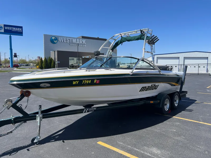 Slide: The Image of 2003 Malibu 23 XTi boat on trailer in parking lot near Westmark Credit Union. - 5