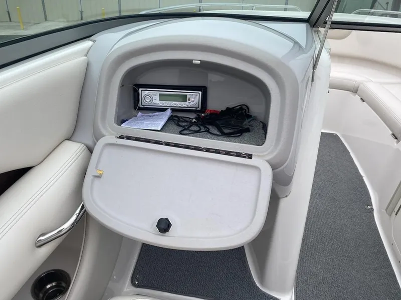 Slide: The Image of 2005 Chaparral 236 SSi boat interior with open glove compartment and stereo system. - 11