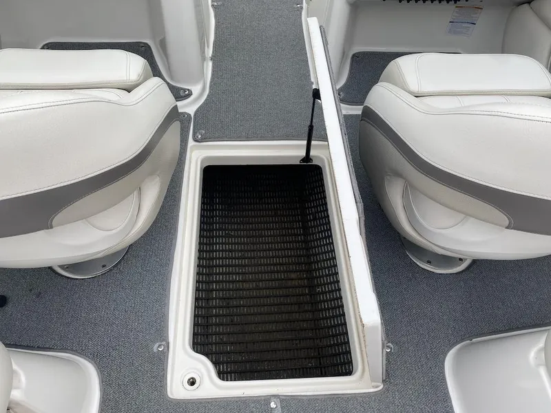 Slide: The Image of 2005 Chaparral 236 SSi boat interior with white seats and storage compartment. - 12