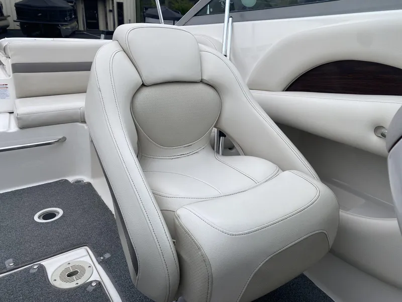 Slide: The Image of 2005 Chaparral 236 SSi boat interior with plush white seating and carpeted flooring. - 13