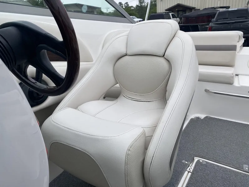 Slide: The Image of 2005 Chaparral 236 SSi boat interior with white captain's seat and steering wheel. - 14