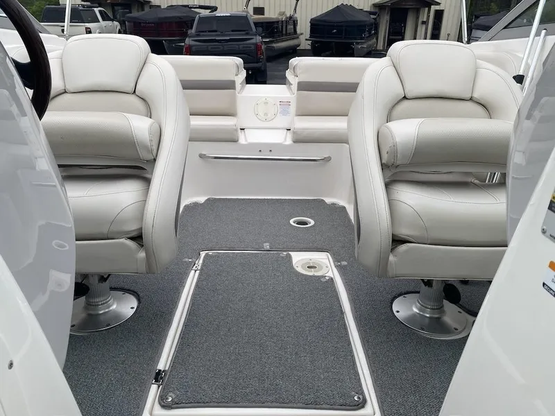 Slide: The Image of 2005 Chaparral 236 SSi boat interior with white seating and carpeted flooring. - 15