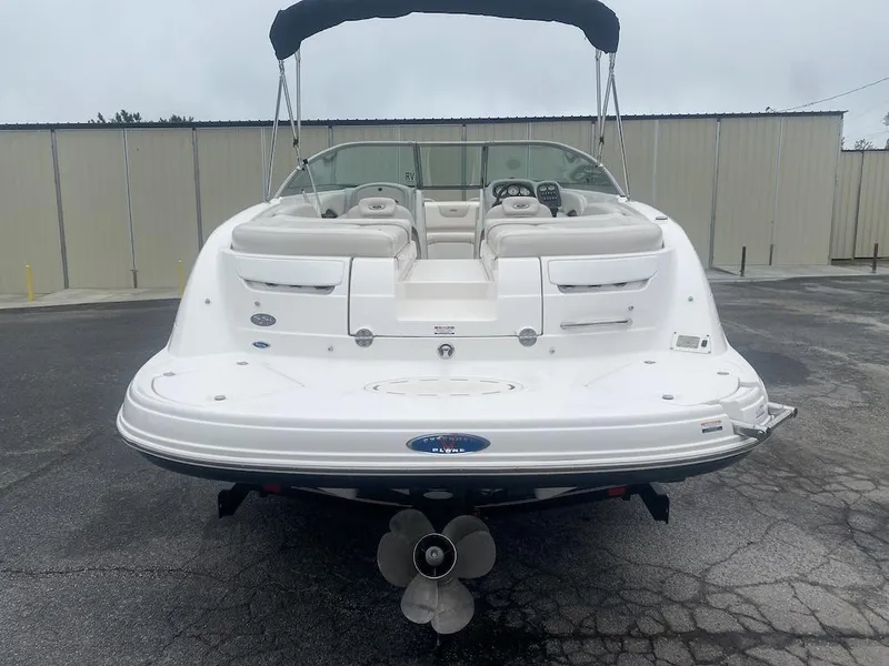 Slide: The Image of 2005 Chaparral 236 SSi boat, rear view, white exterior, parked on pavement. - 2