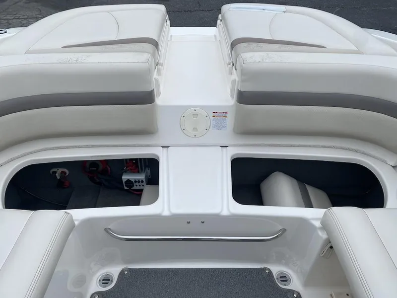 Slide: The Image of 2005 Chaparral 236 SSi boat interior with open storage compartments and cushioned seating. - 20