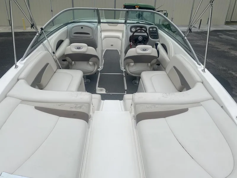Slide: The Image of 2005 Chaparral 236 SSi boat interior with white seating and steering console. - 4
