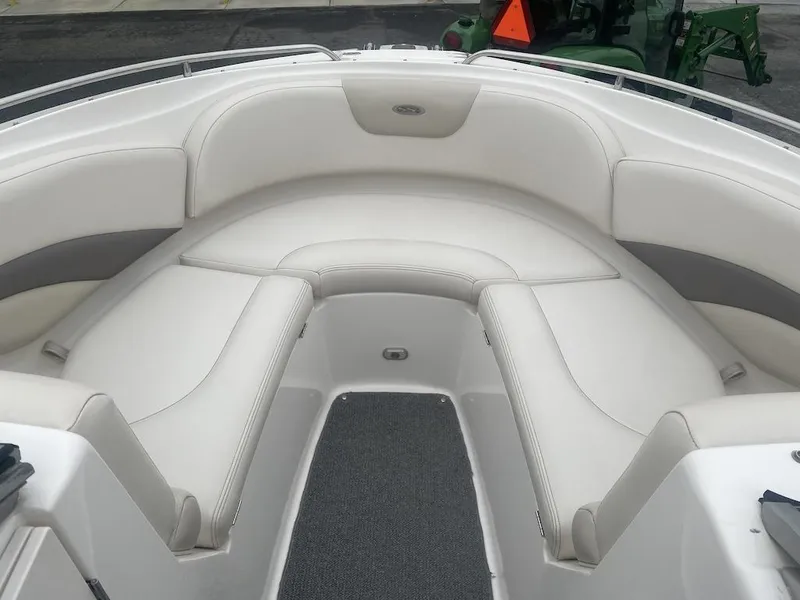Slide: The Image of 2005 Chaparral 236 SSi boat interior with white cushioned seating and gray carpet. - 6